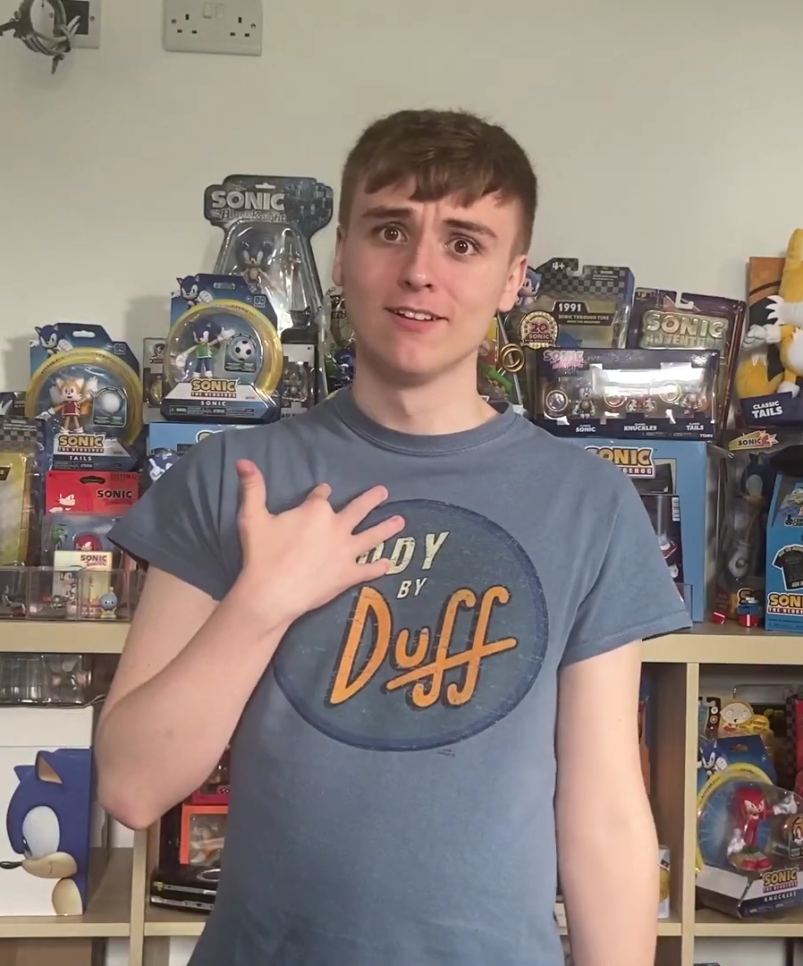 Mark standing near the Great Wall of Unopened Toys